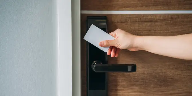 Electronic card key for open door in hotel. Smart card key to lock and unlock door. Security systems and protection concept.